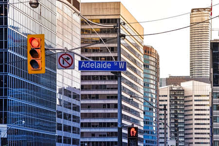 Adelaide Street sign, traffic signals, traffic lights and in the background, buildings in the...