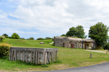 NORMANDY, FRANCE - July 4, 2017: Logo and entrance to the historic site of Batterie d'Azeville, in...