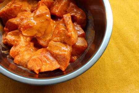 Marinated boneless chicken pieces in a bowl