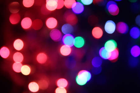 Abstract background of colorful LED lights with bokeh effect glowing at night