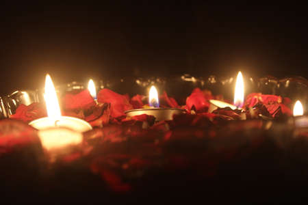 Burning Tea light candles and rose petals in a bowl filled with water