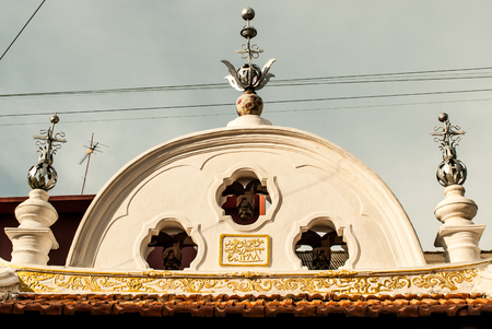 Penang, Malaysia - Bell wall of a temple with arabic writingの写真素材