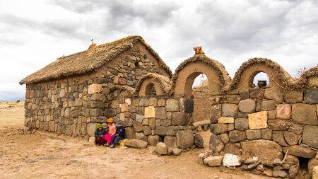 Puno, Peru - December 10, 2011: Children in front of Small farm near Tombs of Sillustani near Puno, Boliviaのeditorial素材