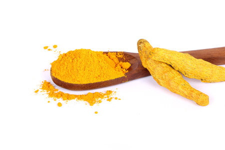 turmeric powder with fresh turmeric root in whiteの写真素材