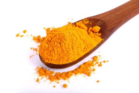 turmeric powder with fresh turmeric root in whiteの写真素材