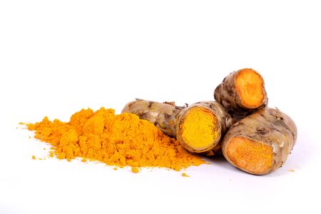 turmeric powder with fresh turmeric root in whiteの写真素材