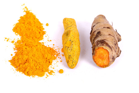 turmeric powder with fresh turmeric root in white