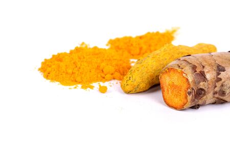 turmeric powder with fresh turmeric root in whiteの写真素材