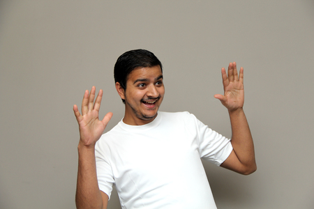 expressions of young amazed man isolated on gray backgroundの写真素材