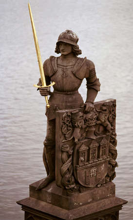 Photo of the ancient statue on the Charles bridge in Prague, Czech republic.From wiki: The avenue of 30 mostly baroque statues and statuaries situated on the balustrade forms a unique connection of artistic styles with the underlying gothic bridge. Most の写真素材