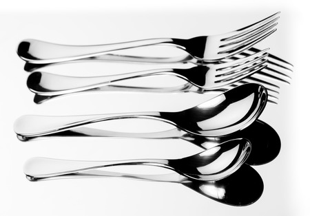 Set of stainless steel fork and spoon reflection on white の写真素材