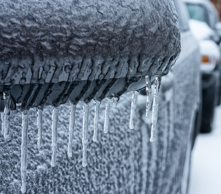 Lines of frozen icicle from vehicle side mirror  The sign of extreme cold and dangers 