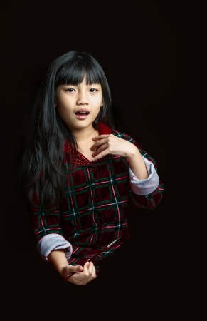 Portrait of cute little girl expressing her feeling about paintingの写真素材