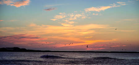 sunrise sunset colorful sky with ocean wavesの写真素材