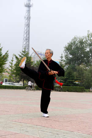 Luannan - September 20: an old man fencing in cultural activities square, the performance on September 20, 2014, the south of the luanhe river, hebei, China.のeditorial素材