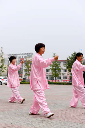 Luannan - September 20: women perform taijiquan in cultural activities square, on September 20, 2014, the south of the luanhe river, hebei, China.のeditorial素材