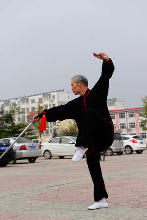 Luannan - September 20: an old man fencing in cultural activities square, the performance on September 20, 2014, the south of the luanhe river, hebei, China.のeditorial素材