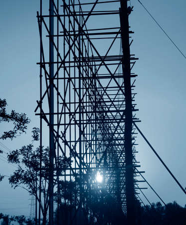 Construction steel frame under the setting sunの写真素材