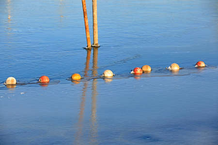 buoys and net floating on the water