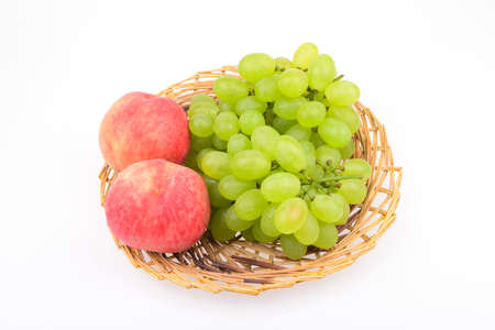 Fruit in the basket isolated on a white backgroundの写真素材