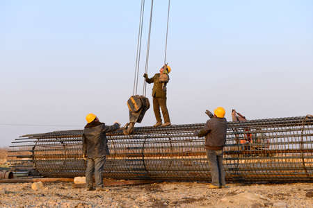Hoisting steel bars in the construction site