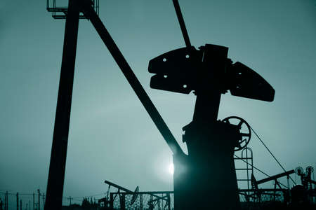 Pumping unit is working, under the sunsetの写真素材