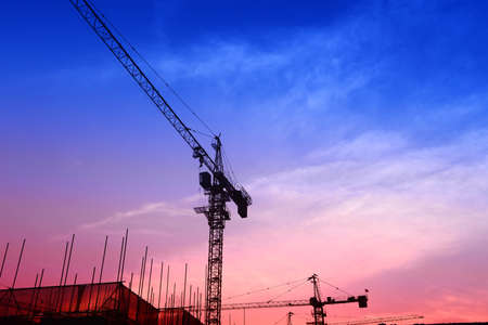 Tower crane work in the evening on the construction site