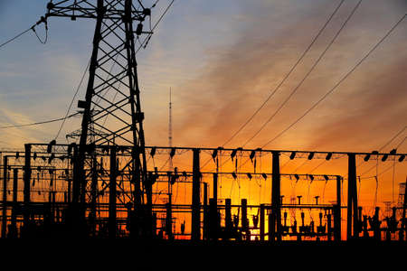A high voltage substation in the sky at sunriseの写真素材