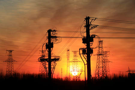 A high voltage substation in the sky at sunriseの写真素材