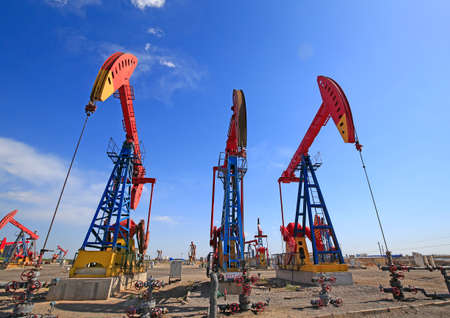 Oil pumps are working in the blue sky background
