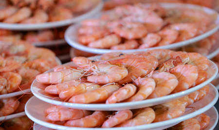 Lots of cooked prawns on a plateの写真素材