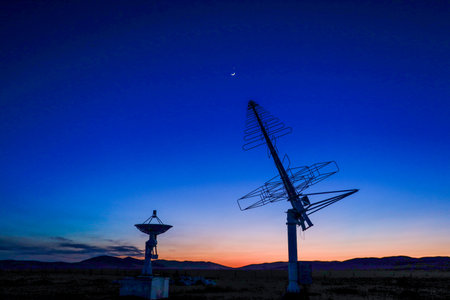 Astronomical telescope equipment, silhouette at sunsetの写真素材