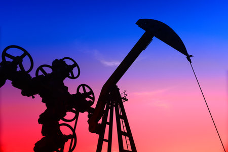 The pumping unit is working, in the silhouette of sunsetの写真素材