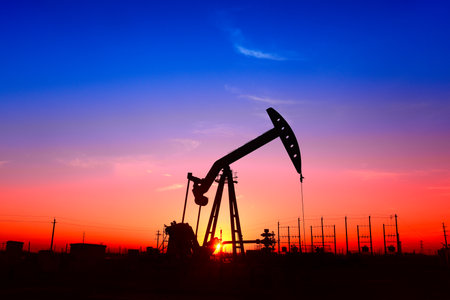 The pumping unit is working, in the silhouette of sunsetの写真素材