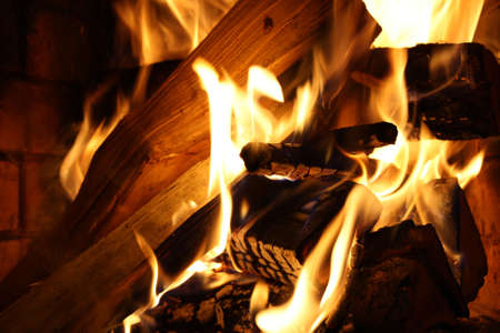 Burning fire wood in a fireplaceの写真素材