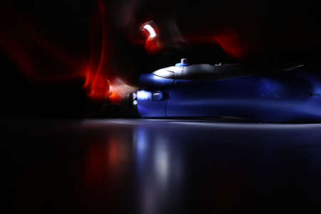 The hair dryer in the dark in colour imagination with a black background