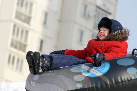 The boy, going for a drive in the winter on tubingの写真素材