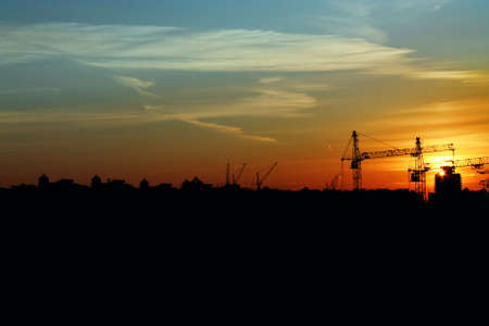 Decline over an under construction city, opposition light and dark, black and goldの写真素材