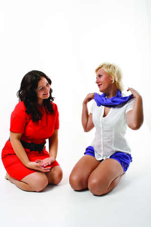 Two women sit next on a white backgroundの写真素材