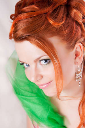 Portrait of the red haired girl with a penetrating glanceの写真素材