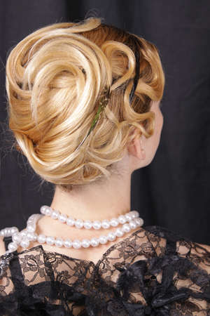 Portrait of the girl in black in a retro style - a hairdress