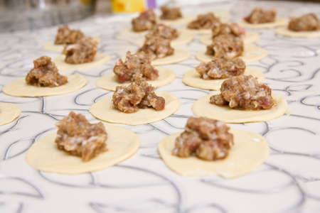 Pelmeni in a flour, spread out to a tableの写真素材
