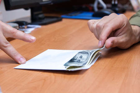 The transfer of an envelope with a bribeの写真素材