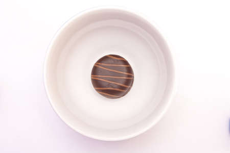Sweet cake with chocolate on plate isolated on whiteの写真素材