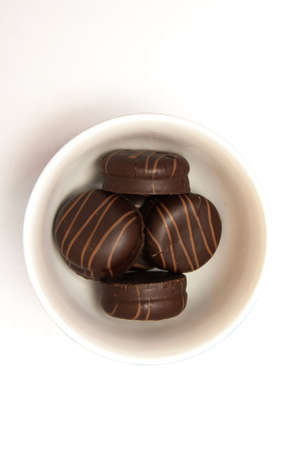 Sweet cake with chocolate on plate isolated on whiteの写真素材