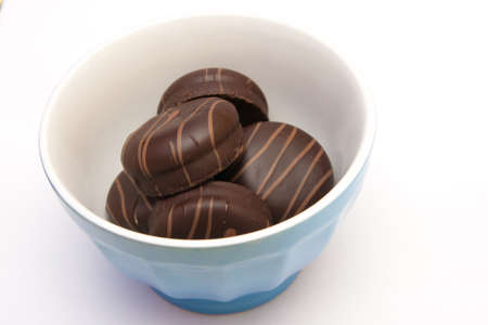Sweet cake with chocolate on plate isolated on whiteの写真素材