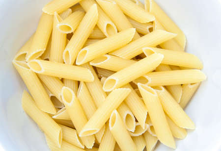 Yellow macaroni, vermicelli food background in dishの写真素材