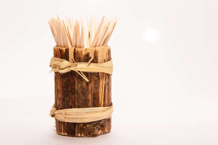 Wooden toothpicks in a stand on a white backgroundの写真素材