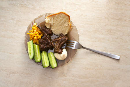 Plate with meat ribs, vegetables and sauces on the tableの写真素材