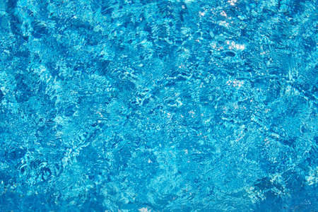 Background of transparent blue in pool water top viewの写真素材